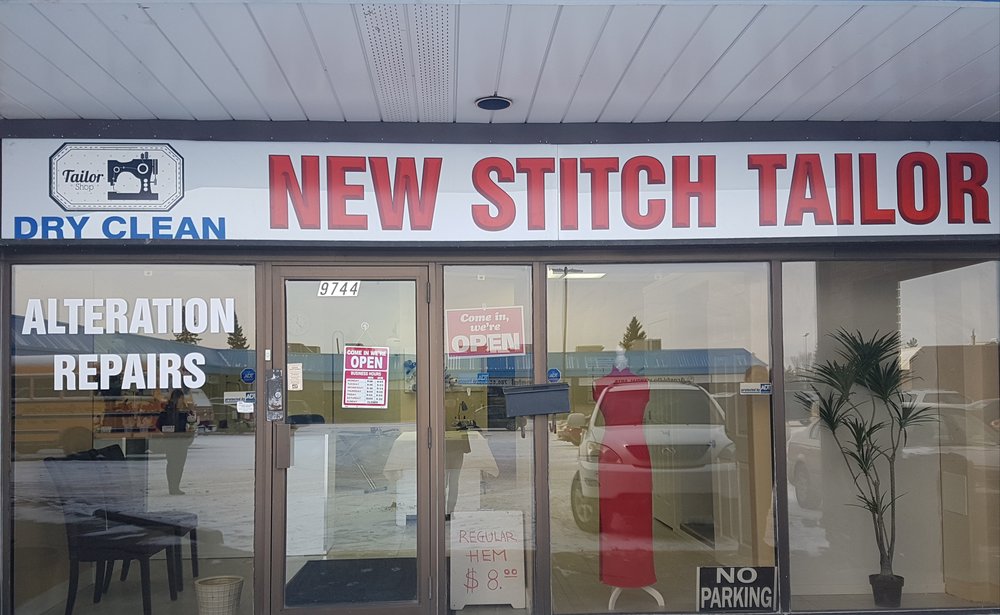The New Stitch Tailor storefront on 182 Street NW in Edmonton — red lettering, alteration and repairs signs in the window, and a mannequin in a red dress